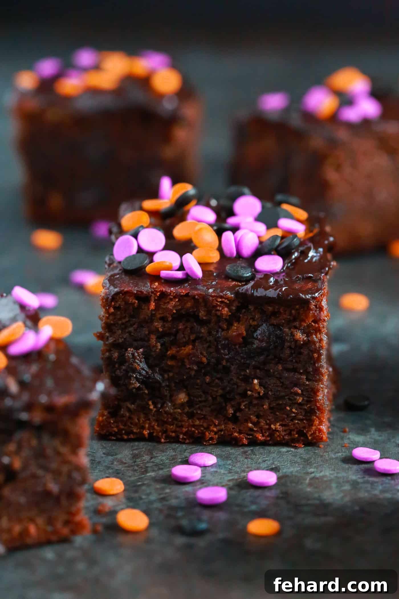 Finished gluten-free Halloween brownies topped with dark chocolate frosting and colorful sprinkles, ready to serve.