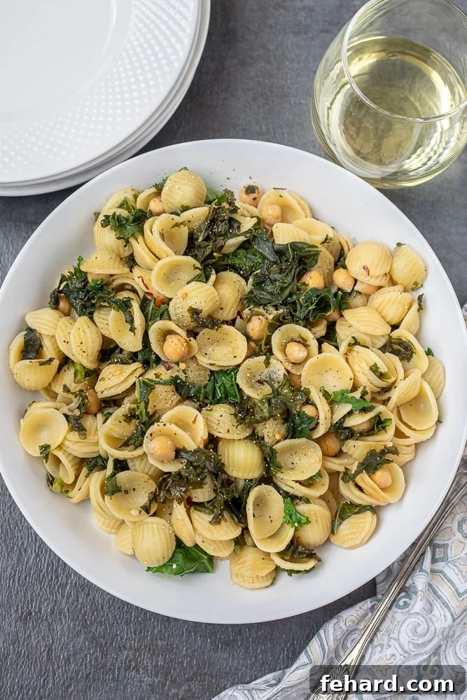 Kale pasta with chickpeas in white bowl