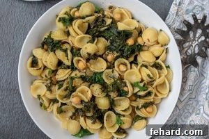 Bowl of pasta with sauteed kale and chickpeas