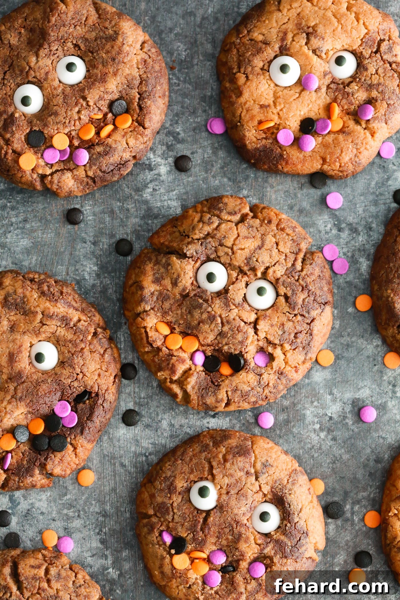 Kid-Friendly Gluten-Free Halloween Monster Cookies with Almond Butter Perfect fun Gluten-free Halloween cookies to make with your kids. They’re made with almond butter, natural sweetener and dark chocolate chips. A close-up shot of several decorated monster cookies on a cooling rack.