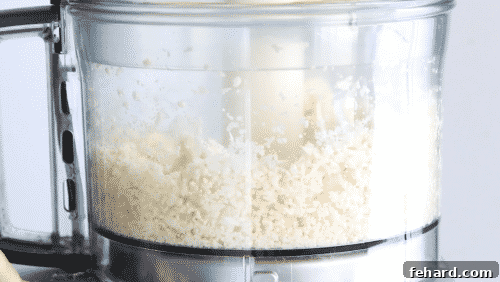Healthy & Delicious Cauliflower Rice 10 cauliflower florets in a food processor bowl