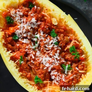 Overhead shot of a single Bolognese Stuffed Spaghetti Squash portion, showcasing the texture and garnish