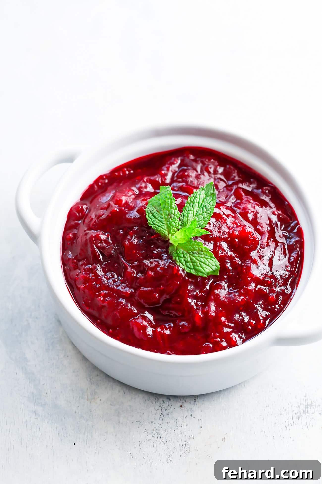 Guilt-Free Cranberry Zing 2 overhead view of instant pot cranberry sauce in a white pot.