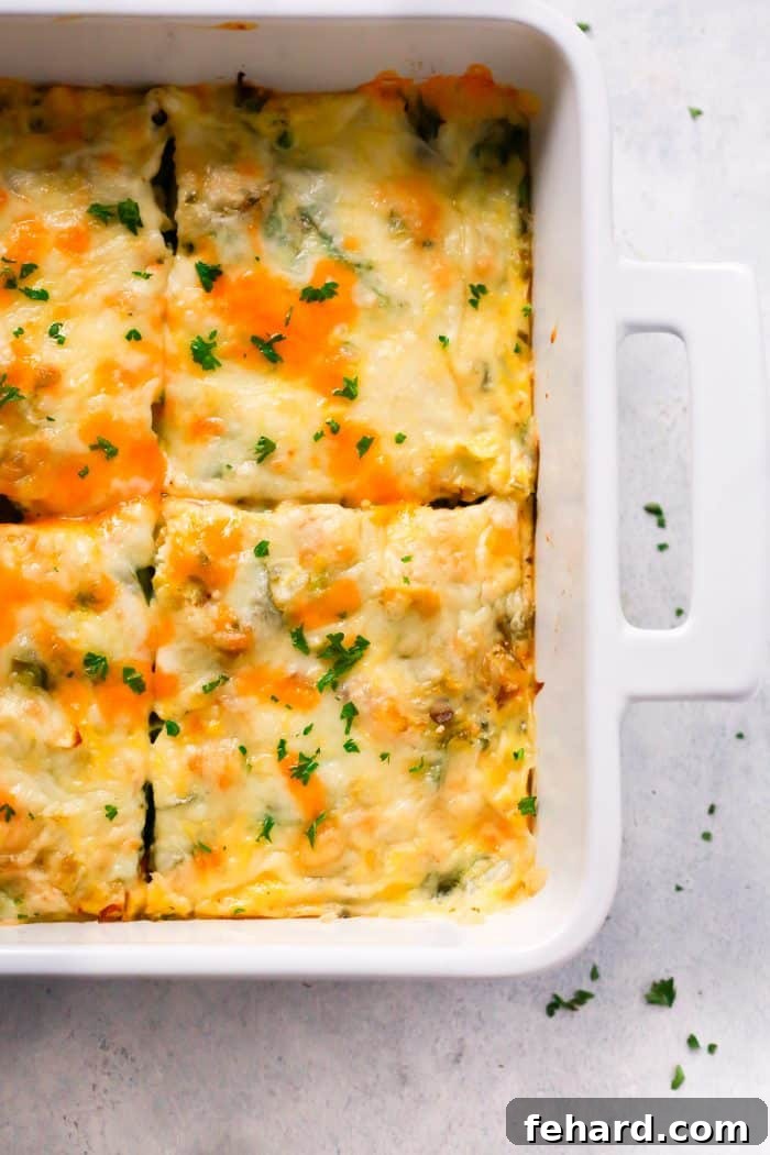 The fully baked and garnished Make-Ahead Veggie Breakfast Casserole, showcasing its golden crust, melted cheese, and fresh herb topping, ready to be served.