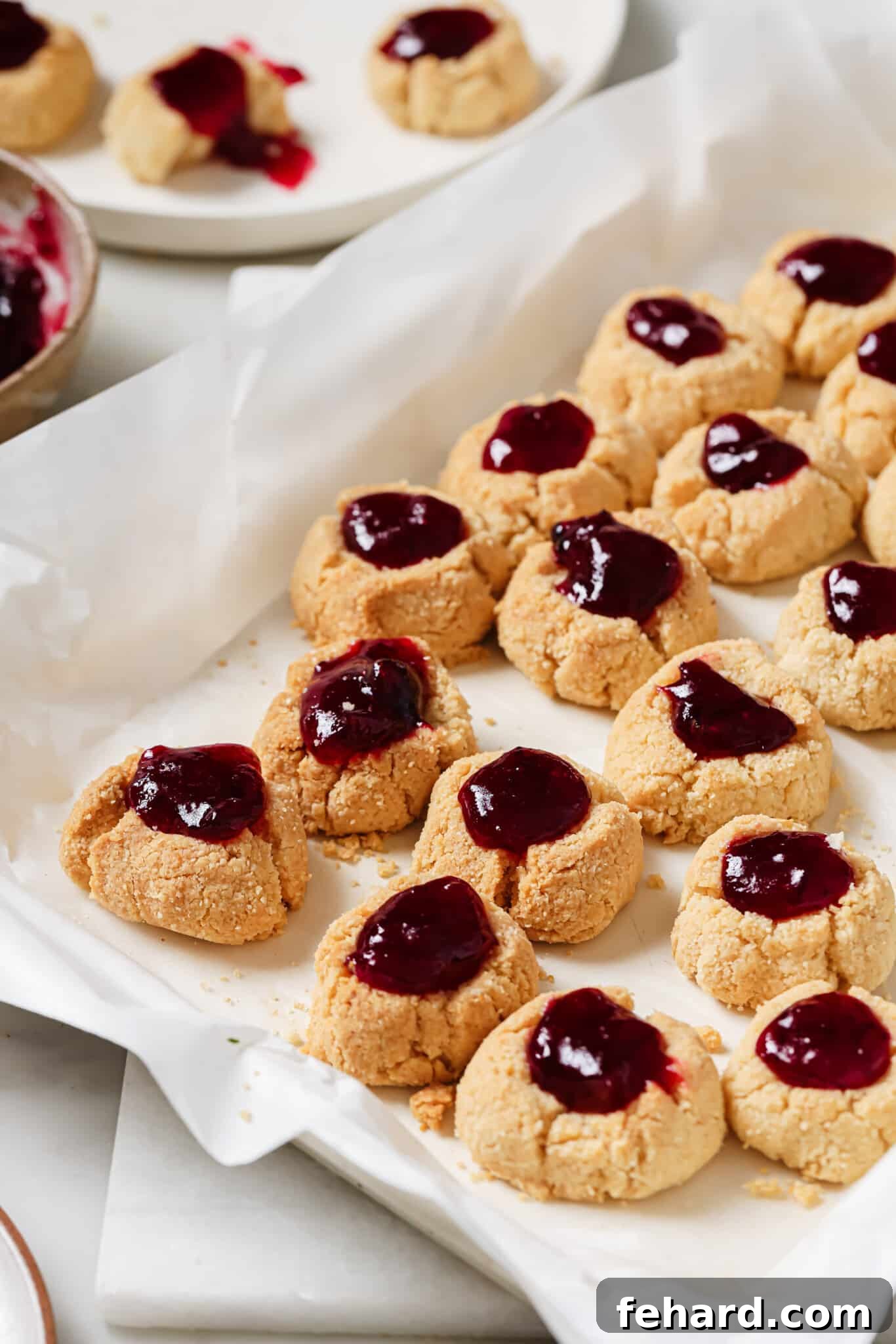 Cranberry Thumbprint Cookies on a baking sheet, ready for serving or gifting.