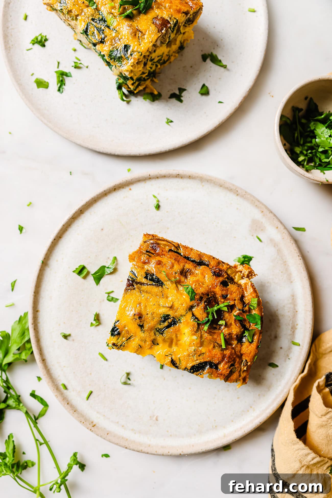 A serving of spinach mushroom frittata on a white plate. 