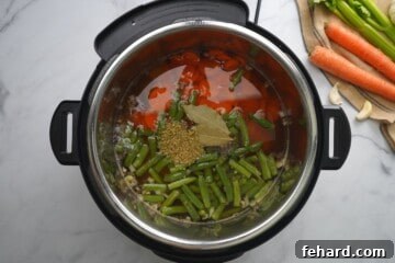 Ingredients for vegetable soup layered in inner pot.