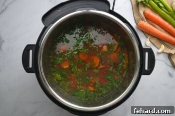 Vegetable soup after adding greens to inner pot.
