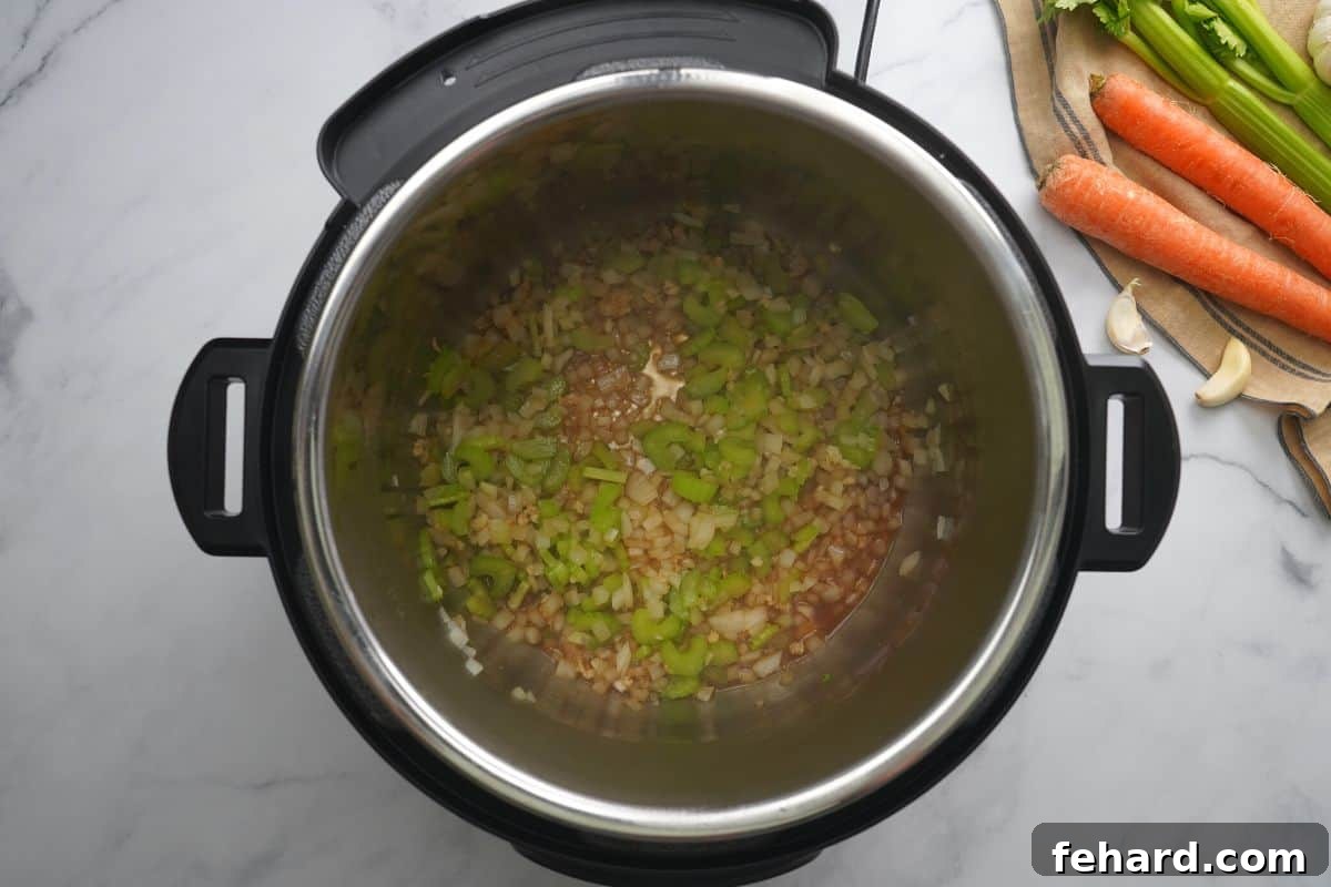 Red wine being poured into the Instant Pot after sautéing, ready for deglazing.