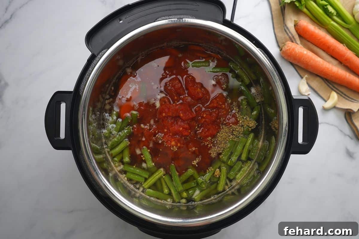The perfectly pressure-cooked vegetable soup visible inside the Instant Pot inner pot, ready for final touches.