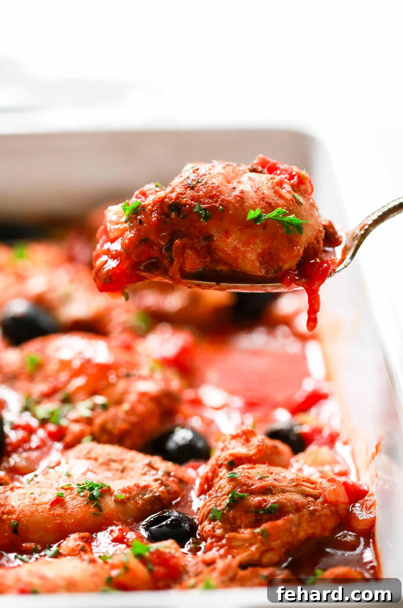 Instant Pot Mediterranean Chicken Feast 2 Instant Pot chicken recipe in a white serving dish, garnished with fresh herbs and olives.