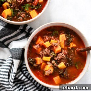 overhead view of two bowls containing Ground Beef Butternut Squash Kale Soup