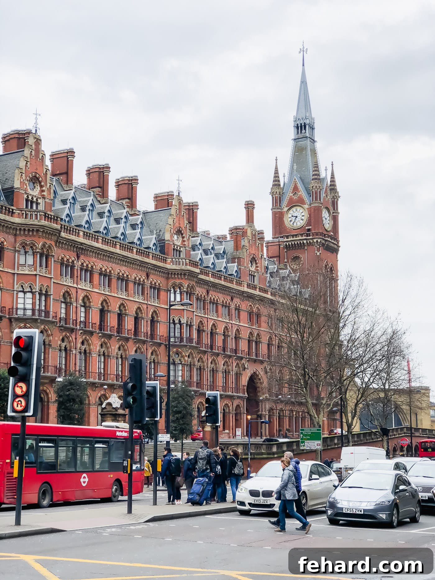 View of a bustling street in London, with traditional red double-decker buses and historic buildings