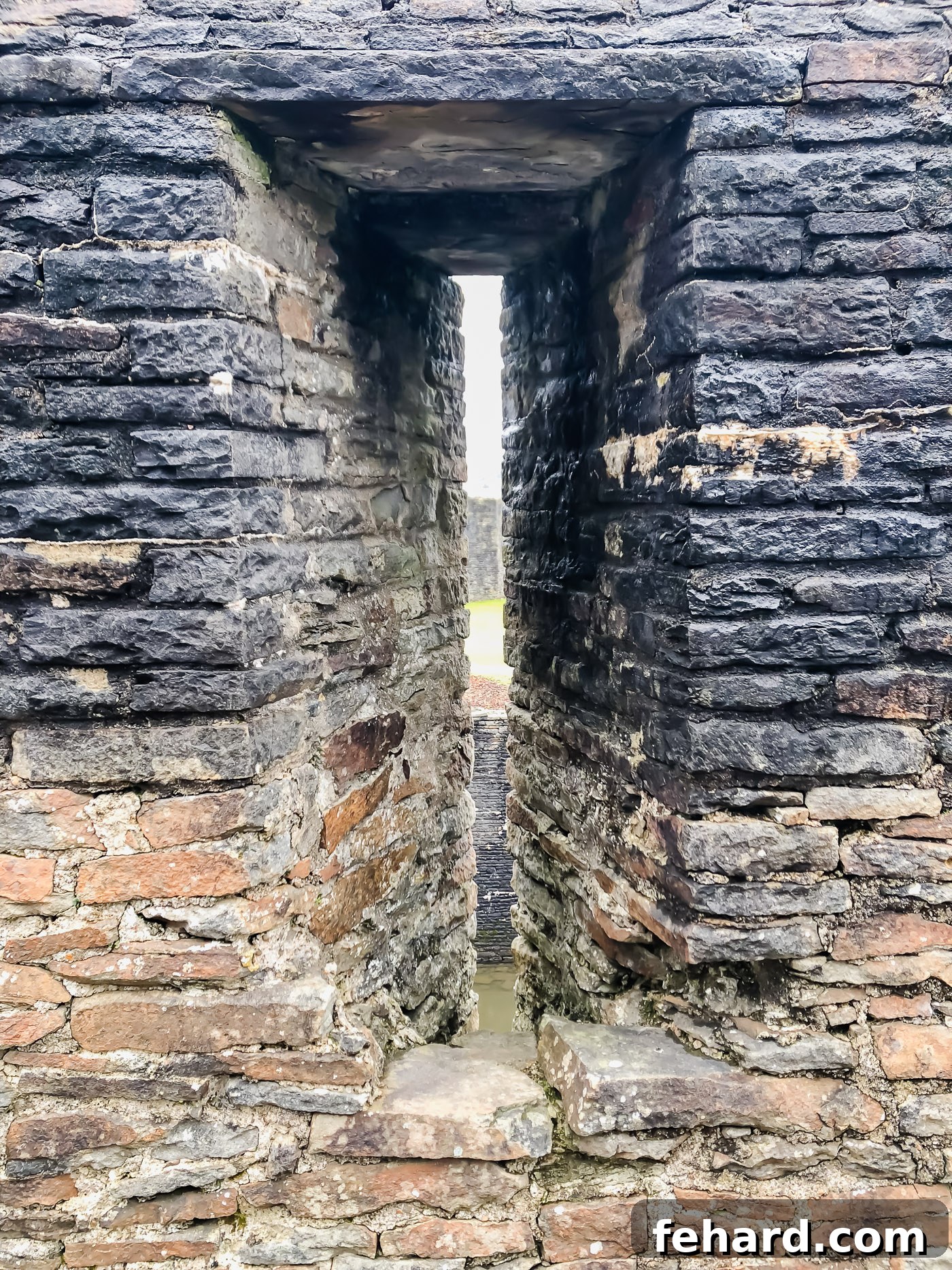 An aerial perspective or wide shot of Caerphilly Castle, emphasizing its strategic location
