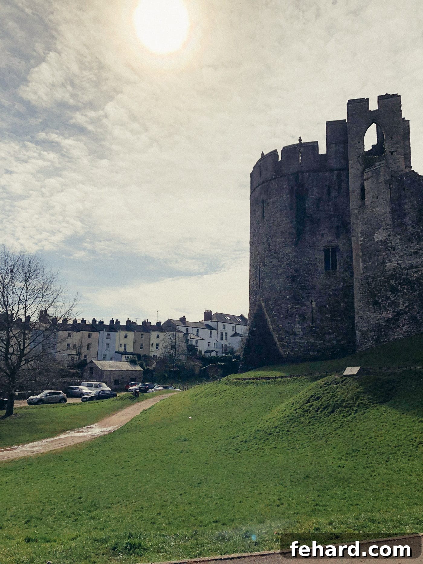 Exterior view of Chepstow Castle with charming, colorful houses nestled around it