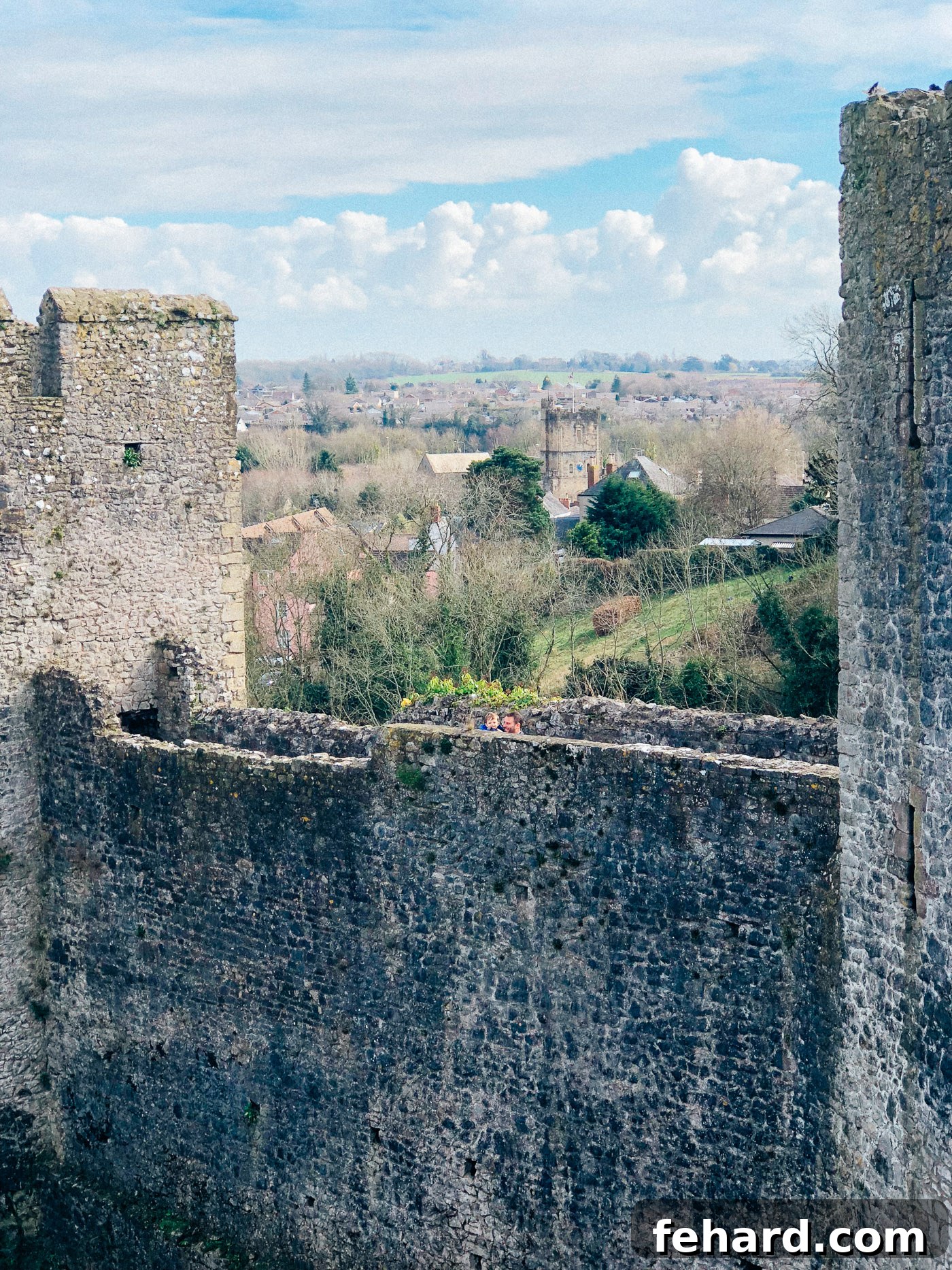 Exterior view of Chepstow Castle under a bright sky, emphasizing its impressive scale