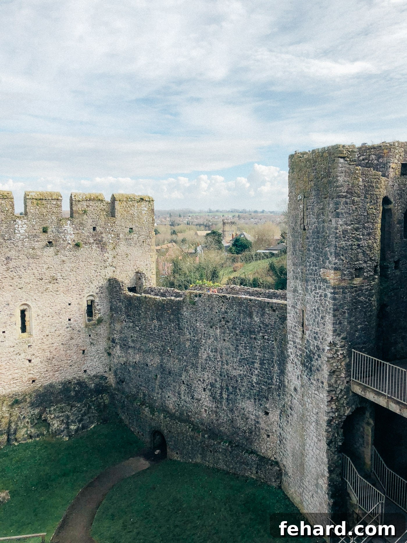 A picturesque exterior view of Chepstow Castle, blending with the natural surroundings