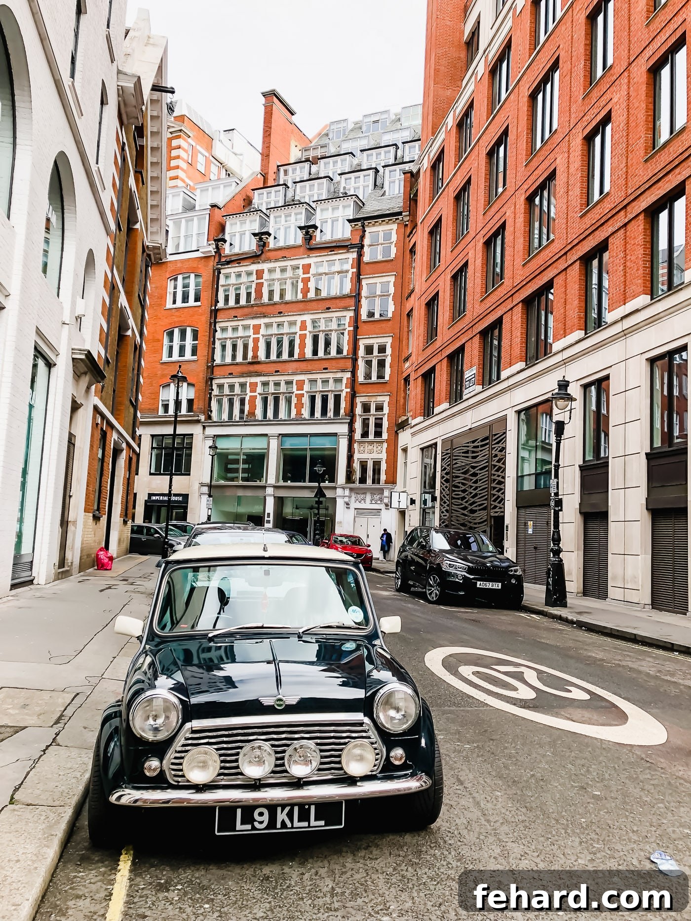 View of a classic black Mini Cooper parked on a London street, embodying British charm