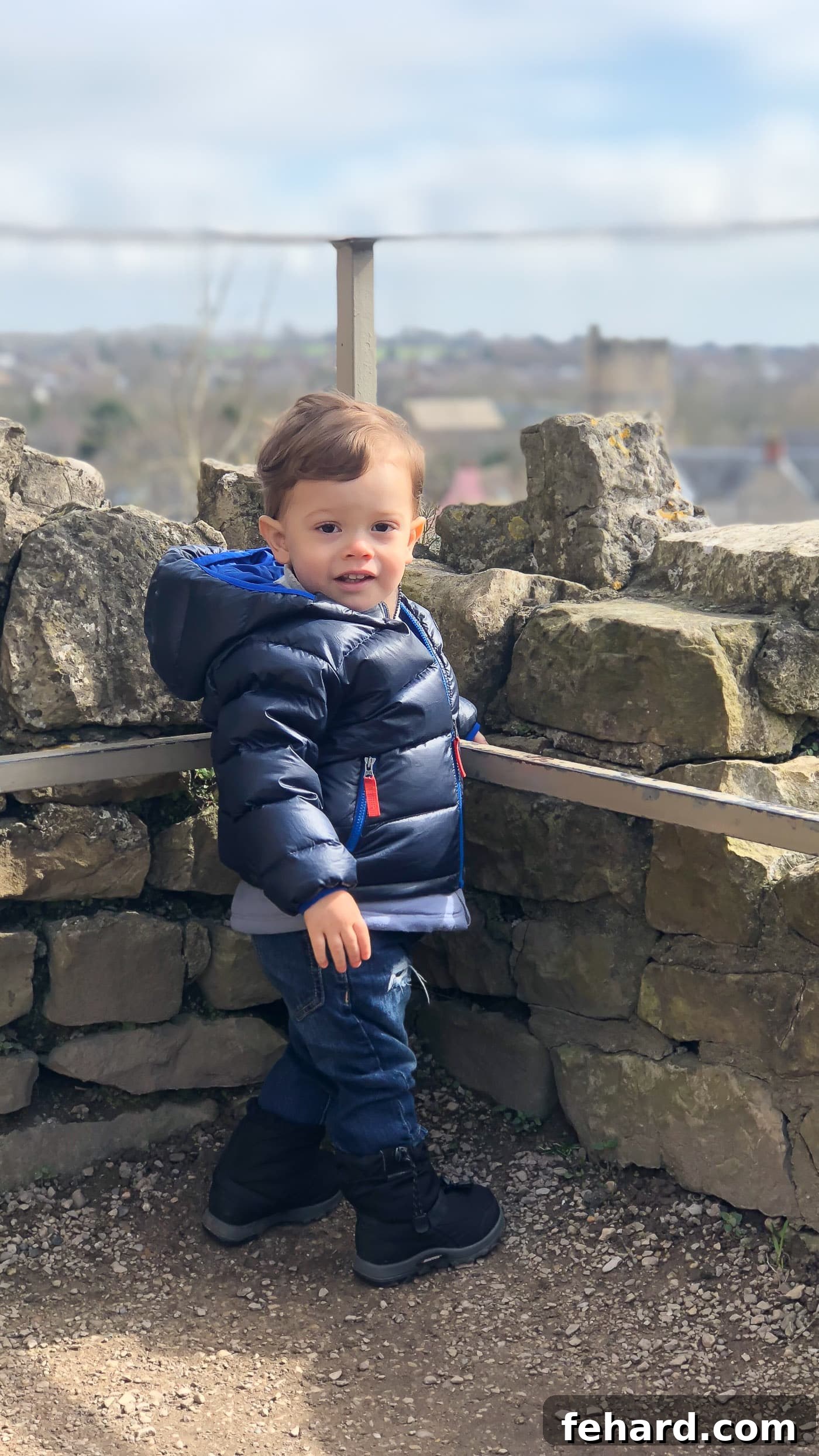 A baby toddler boy exploring the ancient ruins inside Chepstow Castle, a charming juxtaposition
