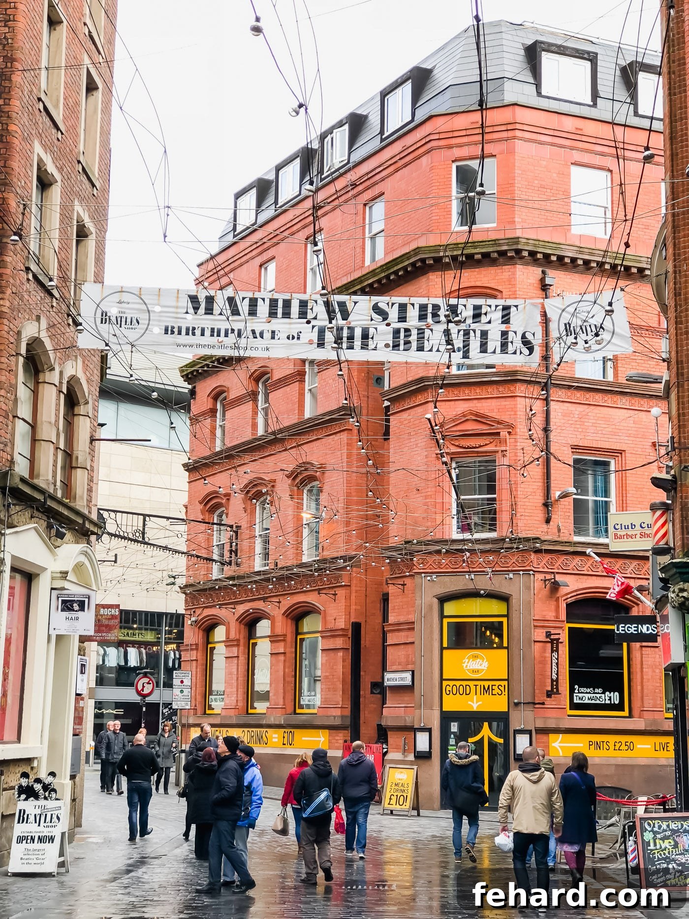 A bustling street view in Liverpool, showcasing historical buildings and city life