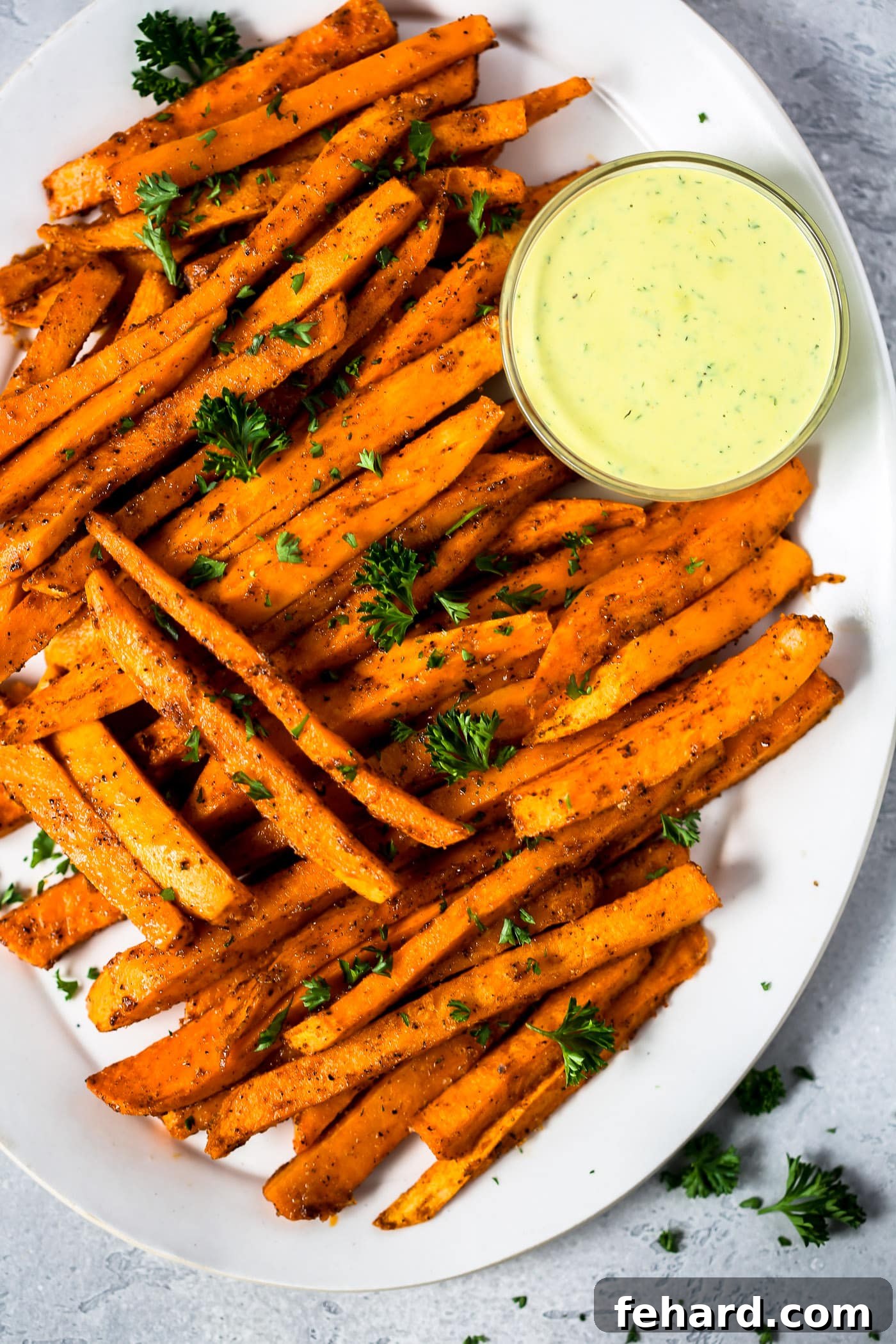 Irresistible Spicy Baked Sweet Potato Fries 3 Close-up of crispy, seasoned Spicy Baked Sweet Potato Fries on a baking sheet, ready to serve