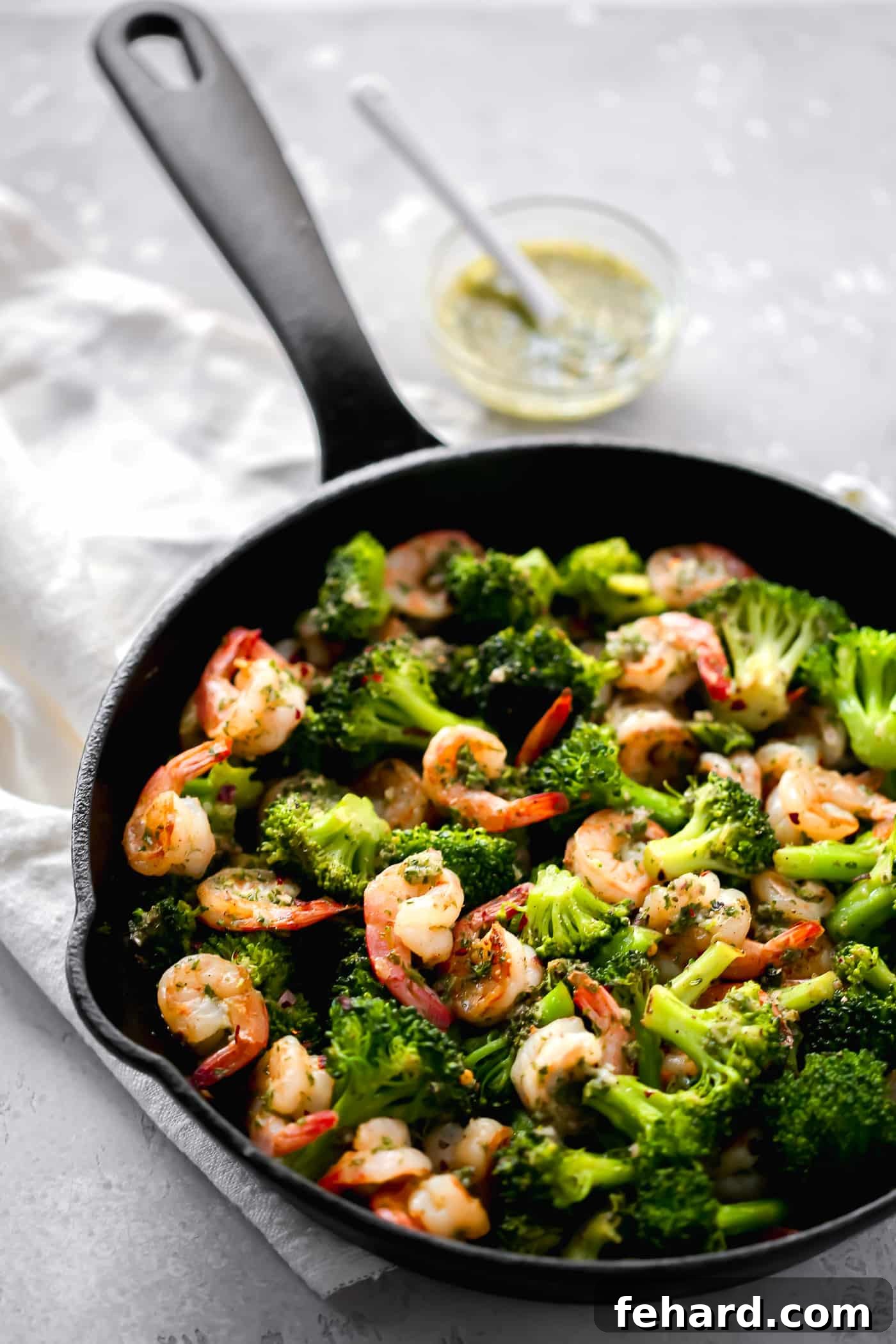 Zesty Chimichurri Prawns 2 A cast-iron skillet filled with perfectly cooked chimichurri shrimp and tender broccoli florets.