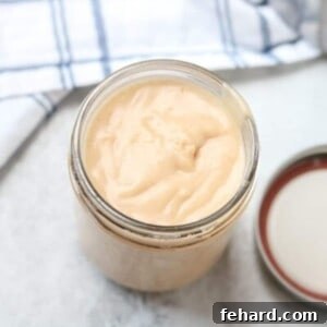 Cream of chicken soup in glass jar, showcasing the condensed texture.