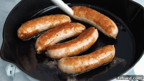 Italian sausage browning in a skillet.