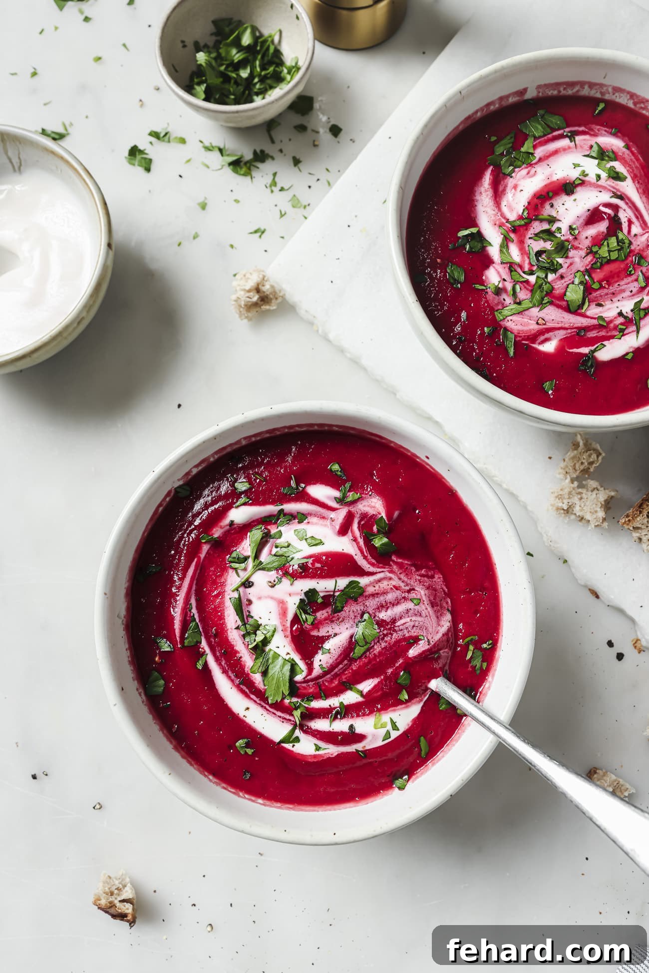 Vibrant Beetroot Soup 6 Two bowls of Beet Soup with garnish.
