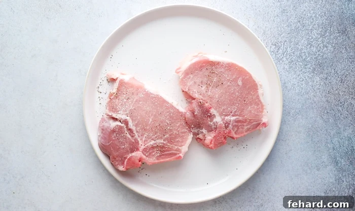 season pork chops with salt and black pepper evenly on both sides