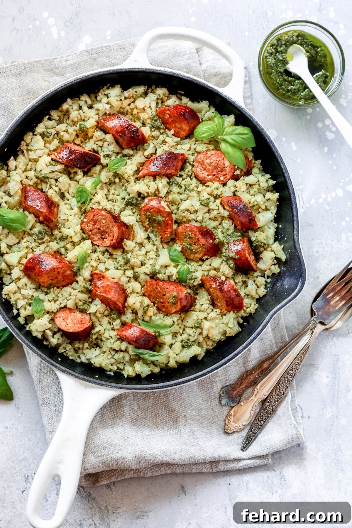 overhead view of a white skillet containing Italian Sausage and Cauliflower Rice 