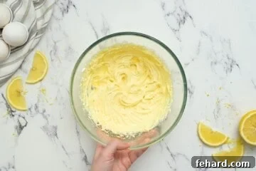 Bowl of cream cheese filling for cheese danish in mixing bowl.