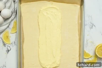 Cream Cheese Filling spread out on center of puff pastry.