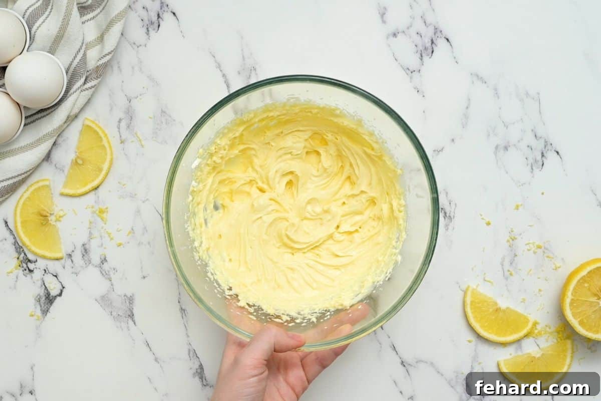 A bowl of perfectly smooth and creamy cream cheese filling for the cheese danish, ready to be spread onto the puff pastry.
