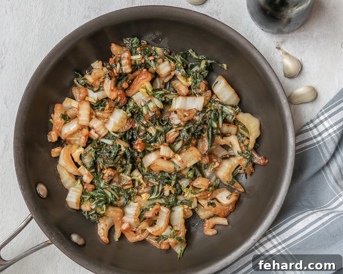 Sauteed Bok Choy in skillet glazed with maple syrup.