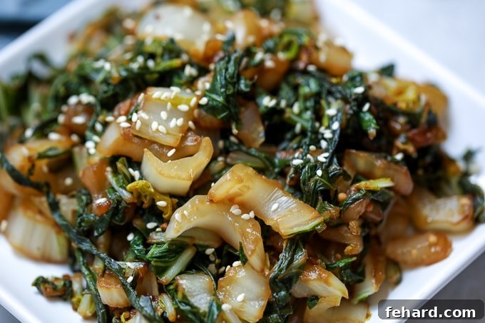 Stir Fried Bok Choy plated on white plate with sesame seeds.