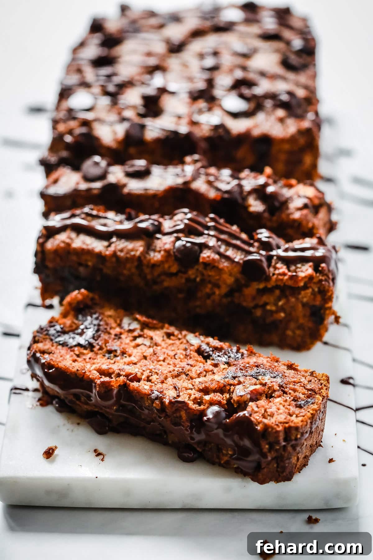 Hazelnut Harvest Pumpkin Loaf 3 Easy Low-carb Pumpkin Bread slices on a cooling rack, showcasing its moist texture