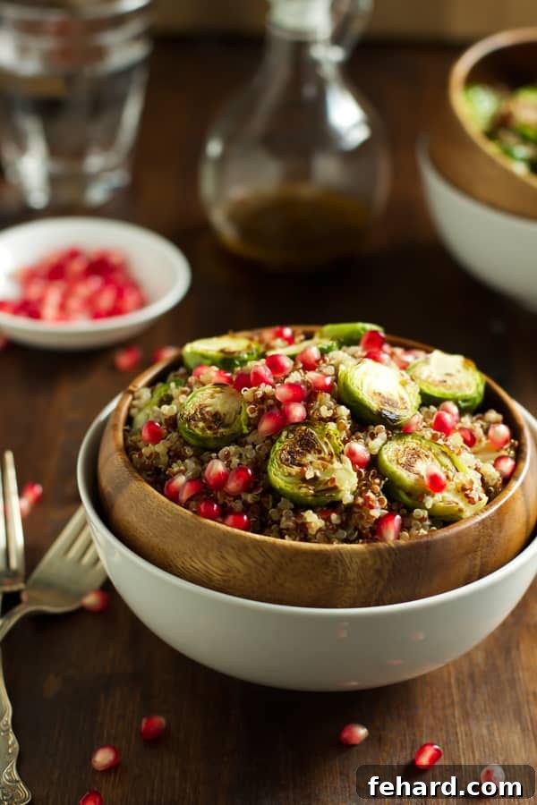 Crispy Roasted Brussels Sprouts Quinoa Bowl 2 Vibrant Quinoa Salad with Roasted Brussels Sprouts and Pomegranate seeds, ready to be served.
