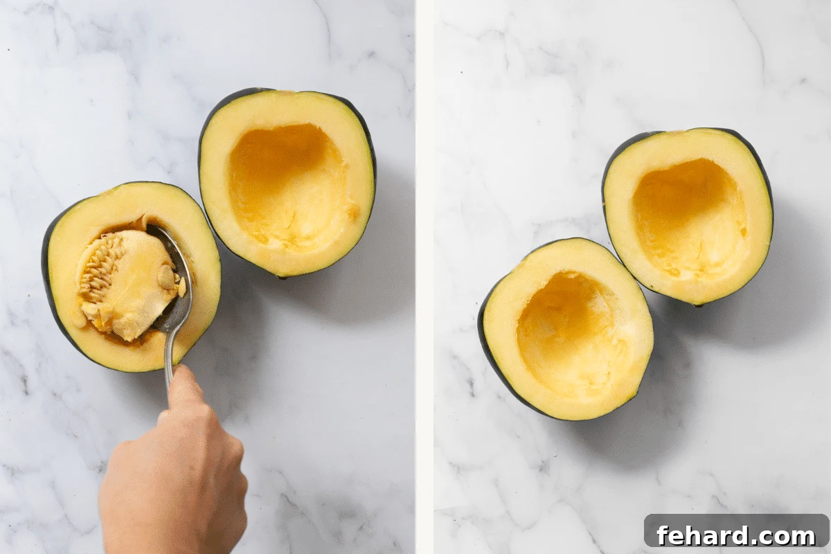 Acorn squash cut in half. A hand of someone scooping the seeds.