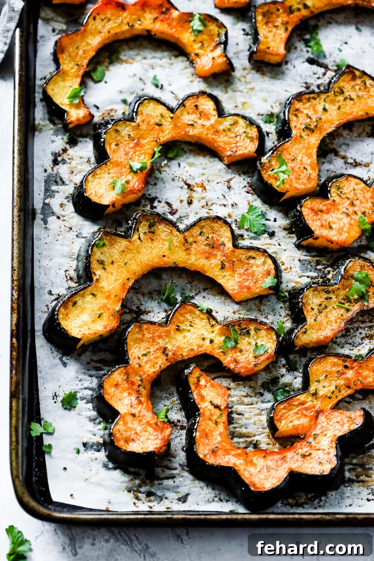 Overhead photo of roasted acorn squash on a sheet pan.