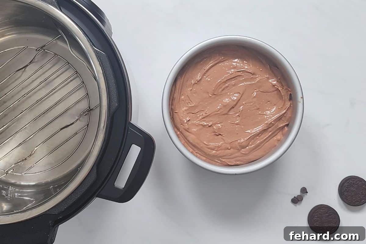Mocha Cheesecake The assembled chocolate cheesecake in its springform pan, positioned next to an Instant Pot, ready for pressure cooking.
