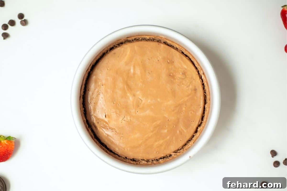 Perfect Chocolate Cheesecake Instant Pot The chocolate cheesecake, perfectly baked and still in its springform pan, showcasing its smooth top after pressure cooking.