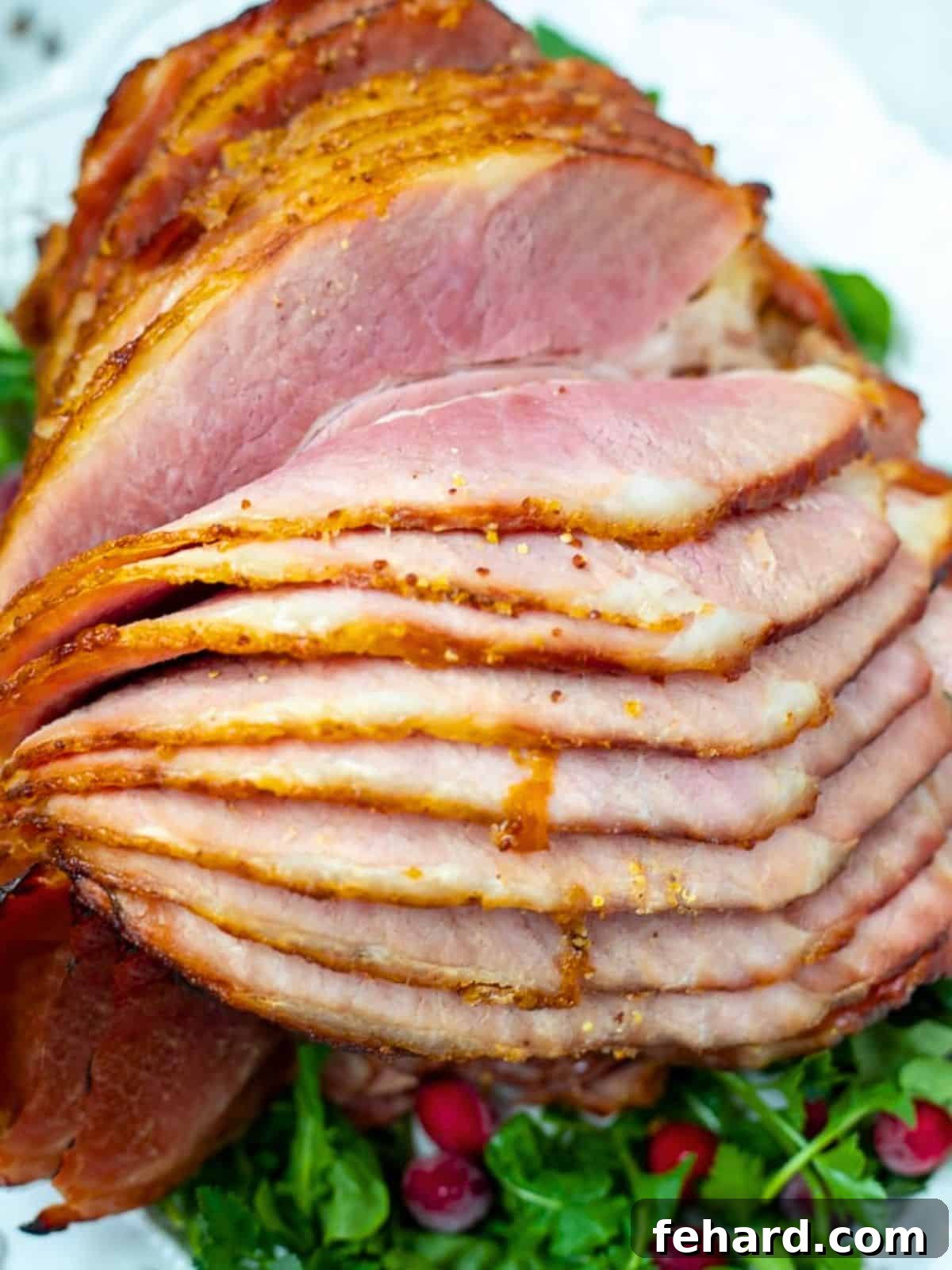 Exquisite spiral-sliced baked ham on a pristine white platter, generously coated with a glistening sweet and savory Dijon pineapple glaze, elegantly presented atop a bed of fresh arugula. The perfect holiday centerpiece.