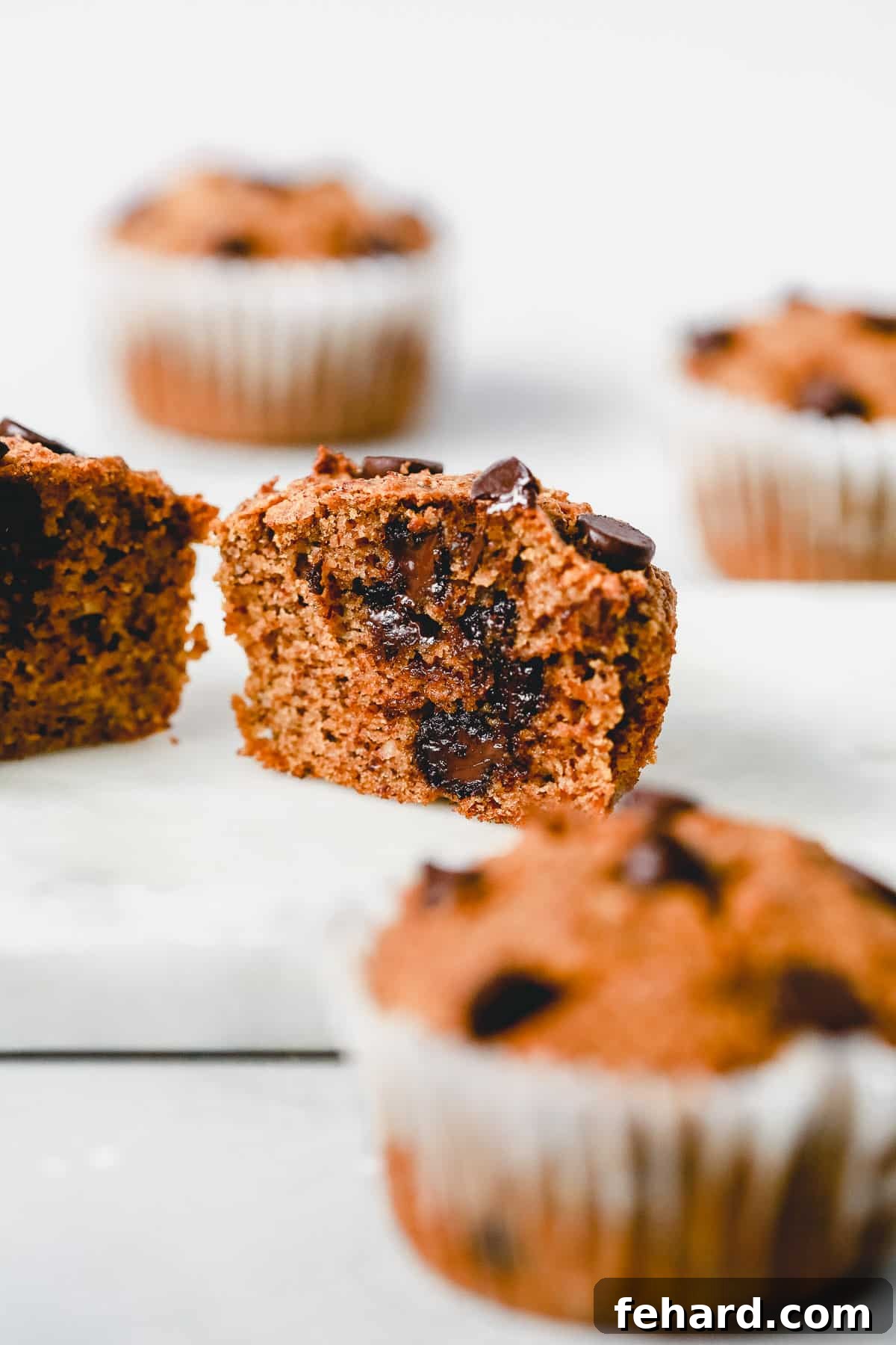 Almond Flour Pumpkin Muffins cut in half showing moist interior