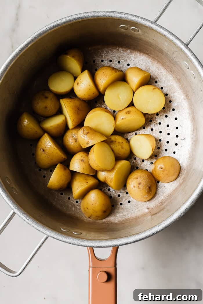 Quick & Fresh Breakfast Salad 4 An overhead view of baby potatoes draining in a pot.