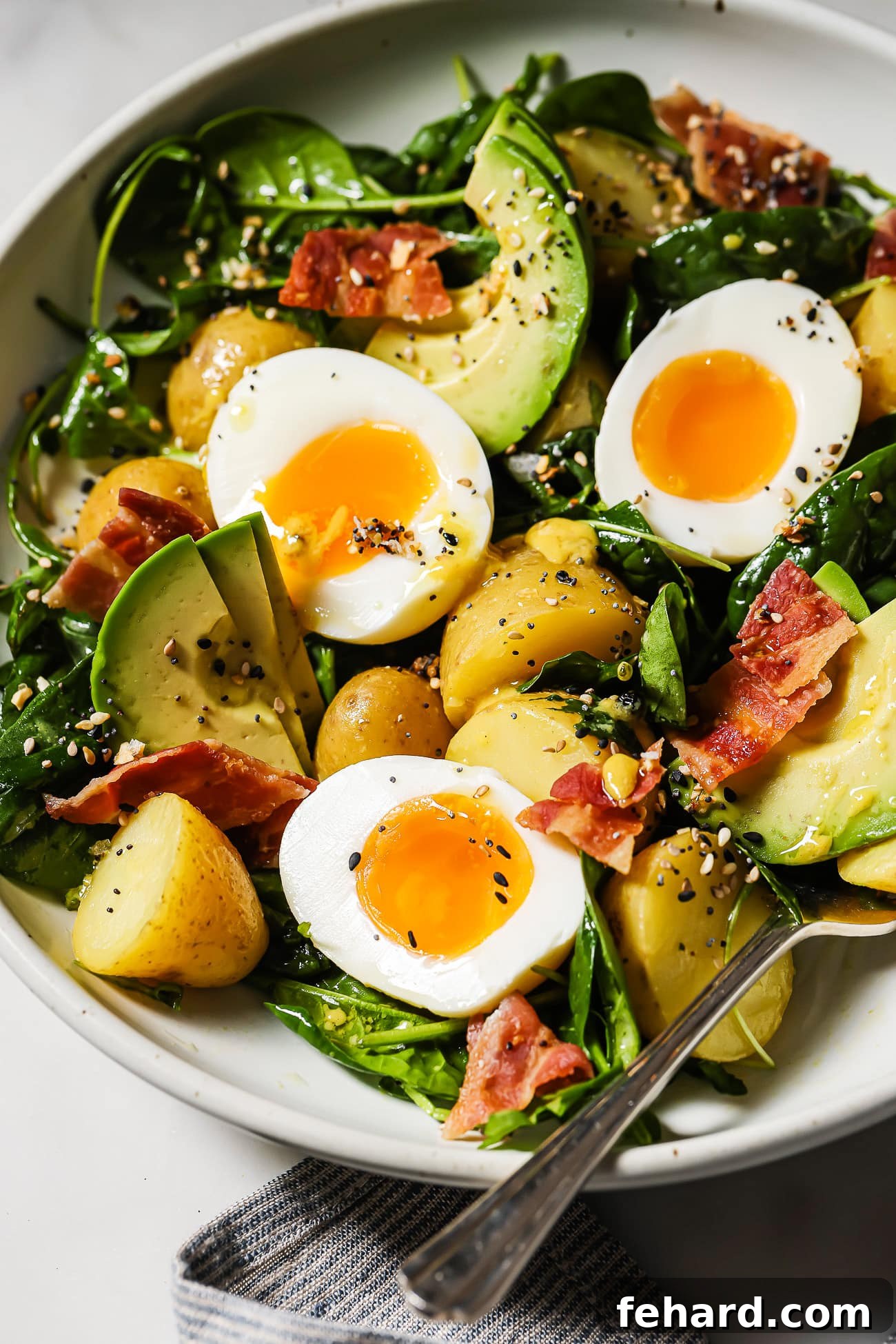 Quick & Fresh Breakfast Salad 8 A closeup of a breakfast salad with eggs, bacon, and avocado.