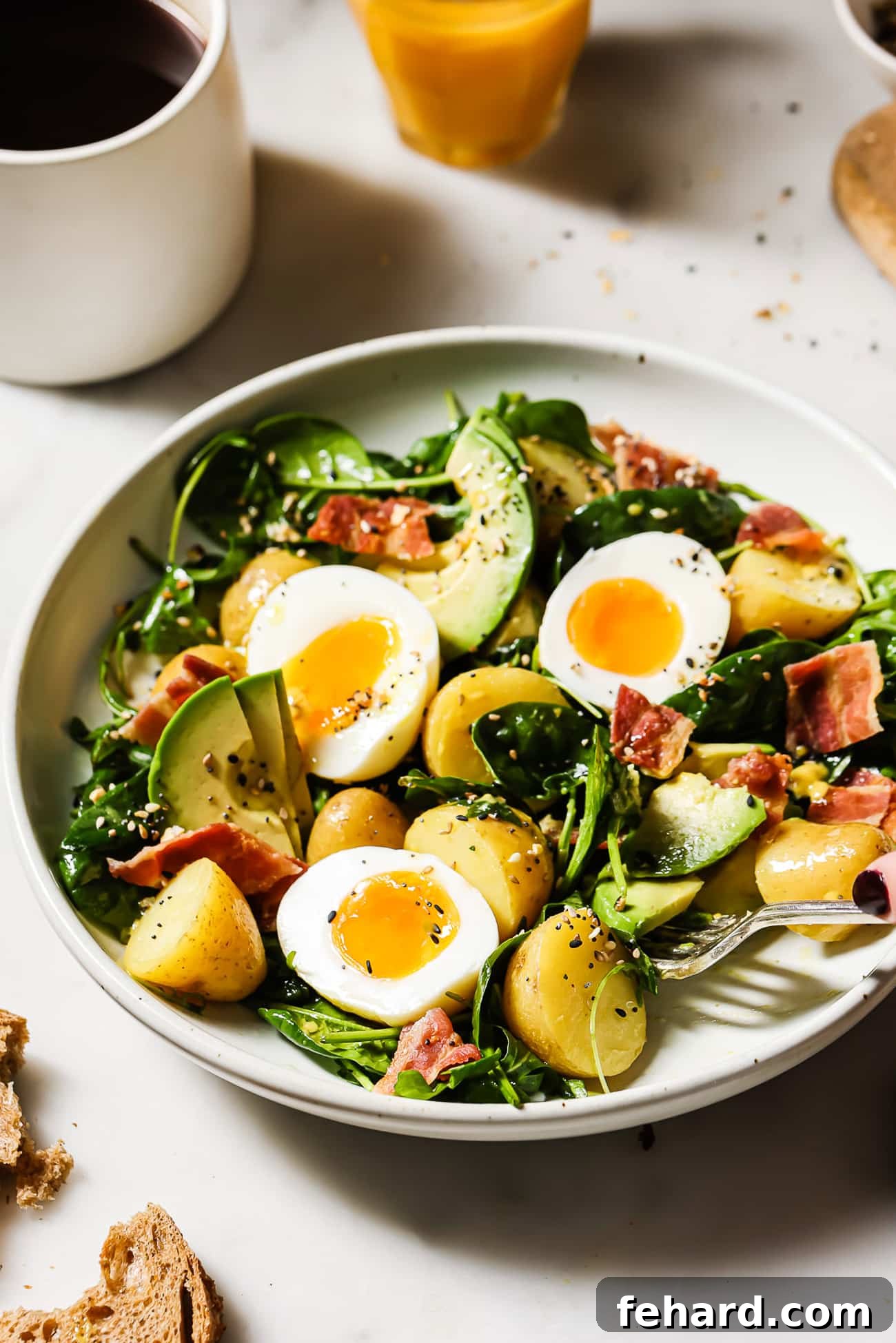 Quick & Fresh Breakfast Salad 10 An overhead view of a breakfast salad with bacon, eggs, and avocado.