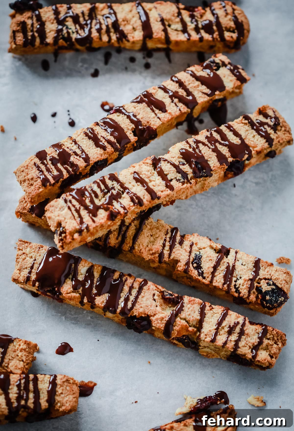 Artisan Chocolate Almond Biscotti 4 4 Chocolate Almond Biscotti Cookies on top of each other on a countertop