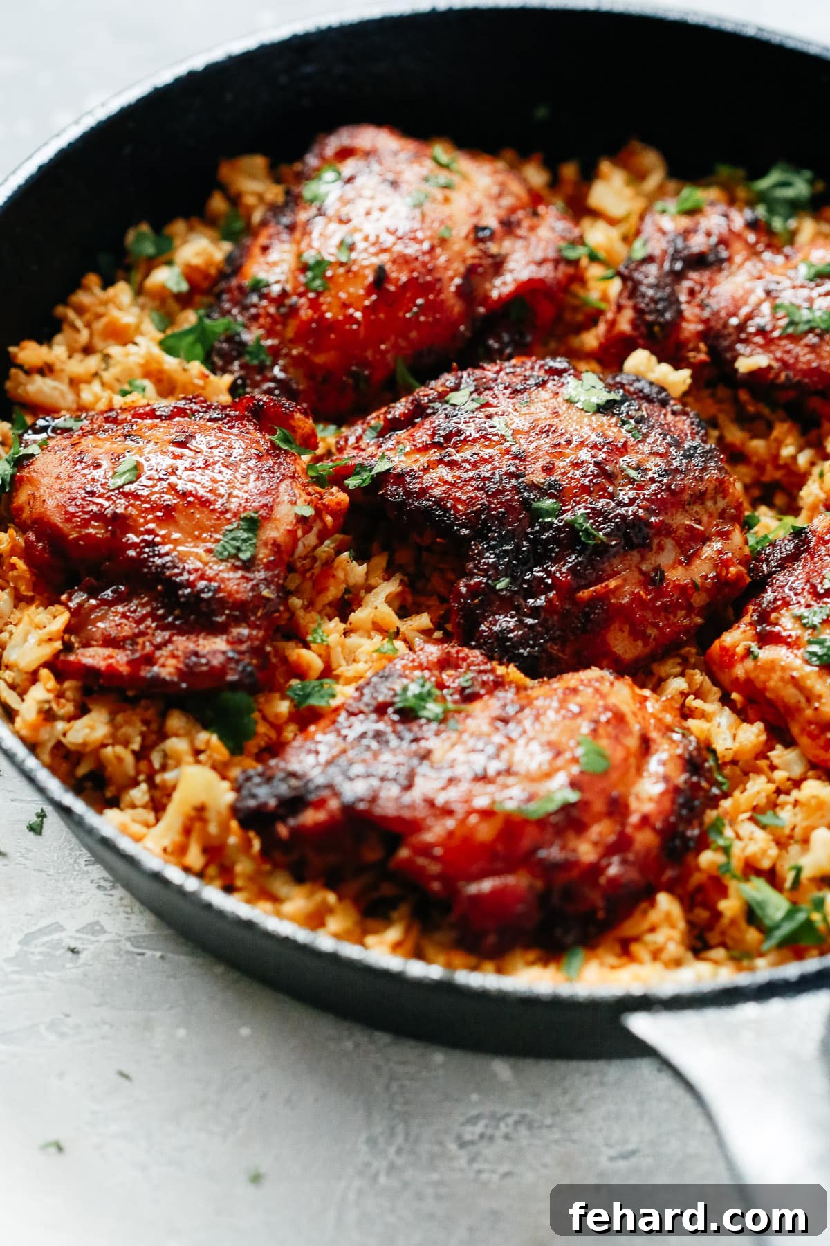 Savory Chicken and Cauliflower Rice 3 Chicken and cauliflower rice beautifully arranged in a skillet, ready to be served.
