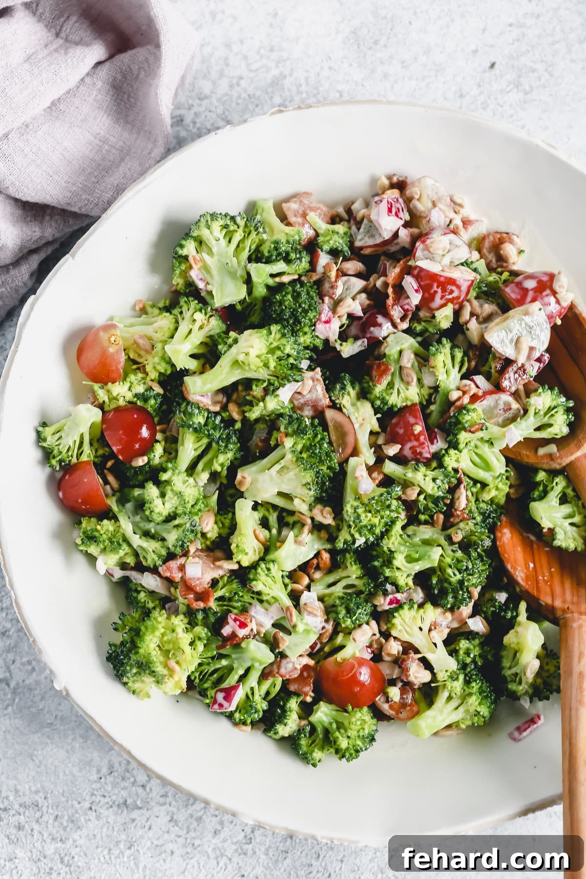 A bowl of fresh, colorful easy broccoli salad, a healthy and vibrant addition to any picnic spread.